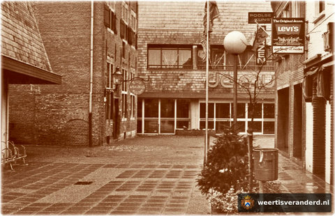 Dit stukje Molenstraat, dat nu doorsneden is door het Muntcomplex, heet nu Muntpromenade. Links zien we nog het Muntgebouw, een van de weinig overgebleven panden van de vroegere Molenstraat.